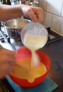 Adding Milk faster, continuing to whisk